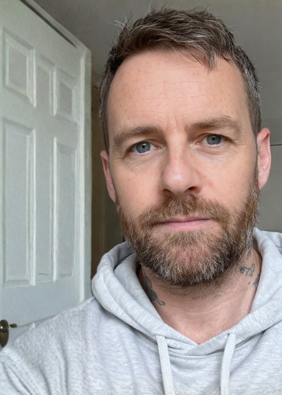 Man holding a bottle of 'Crazy Bull' product in front of a mirror.