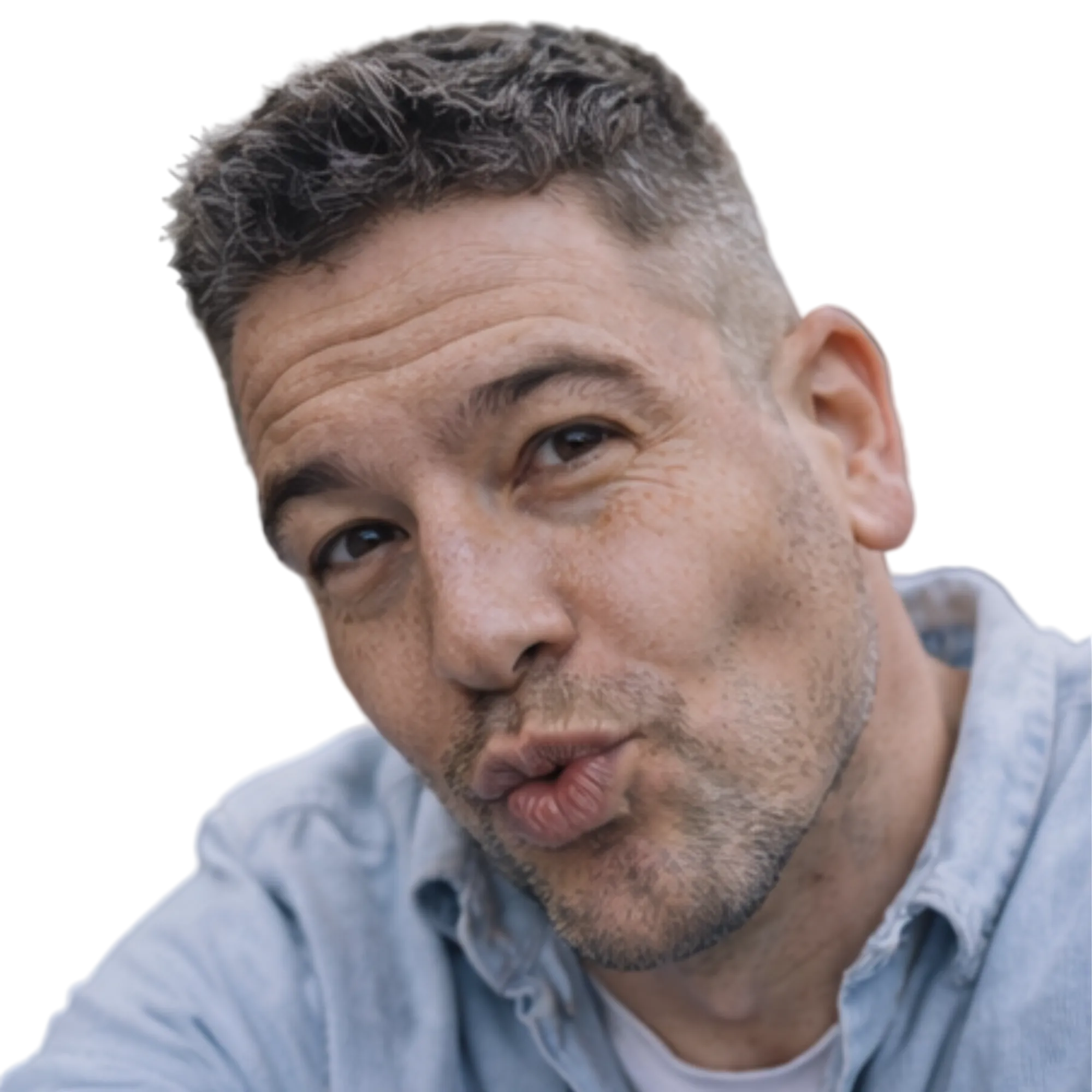 Man with gray hair and beard wearing a light blue shirt outdoors