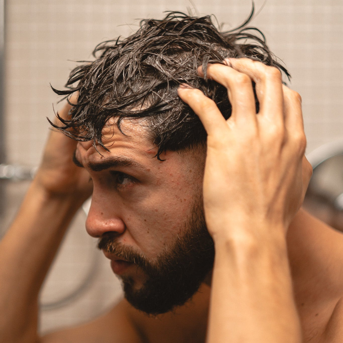 Man with wet hair in a bathroom setting